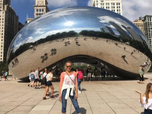 Sylvia Kikuyama in front of Cloud Gate, is a public sculpture by Indian-born British artist Anish Kapoor, that is the centerpiece of AT&T Plaza at Millennium Park in the Loop community area of Chicago, Illinois.